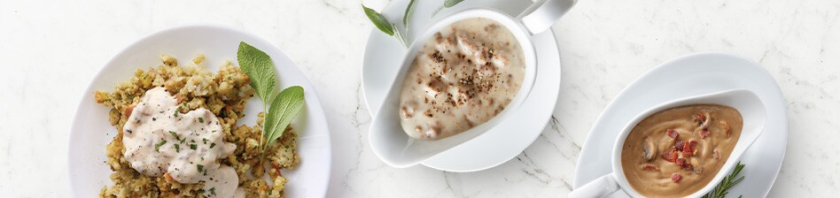 Plated stuffing featuring two different types of gravy in gravy boats - plant based sausage gravy and the other traditional turkey gravy.