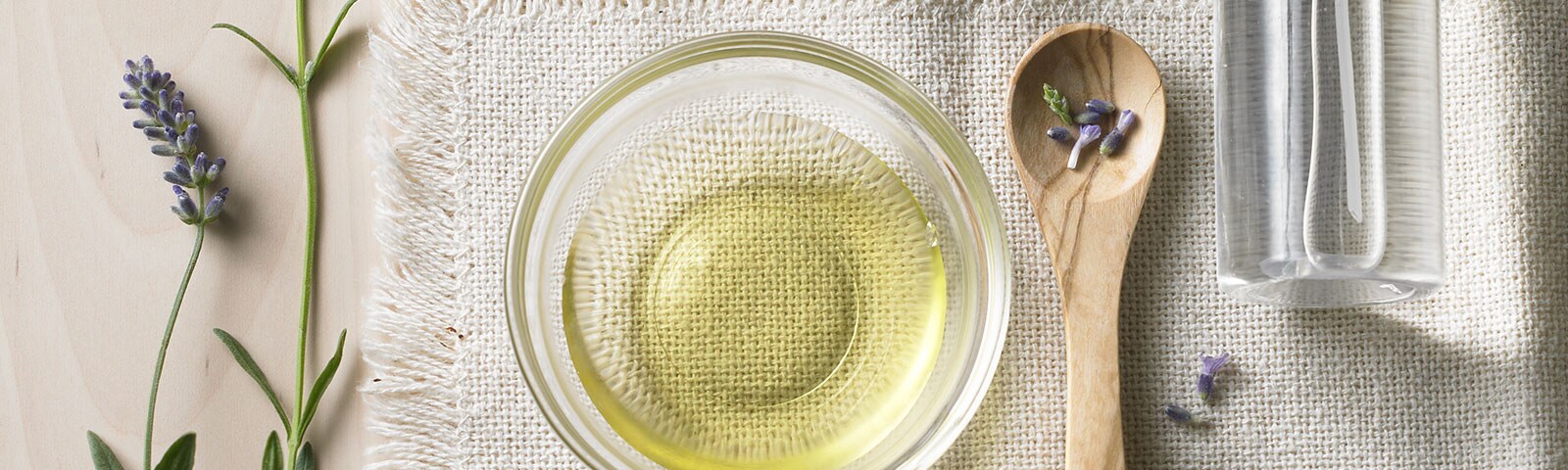 A bowl full of oil atop a linen cloth surrounded by rosemary, clove, eucalyptus herbs and essential oils A bowl full of oil atop a linen cloth surrounded by rosemary, clove, eucalyptus herbs and essential oils