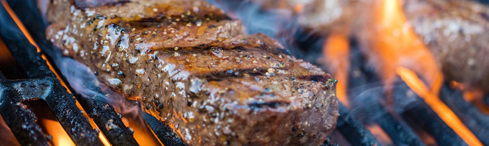 Cooked steak grilling on a grill