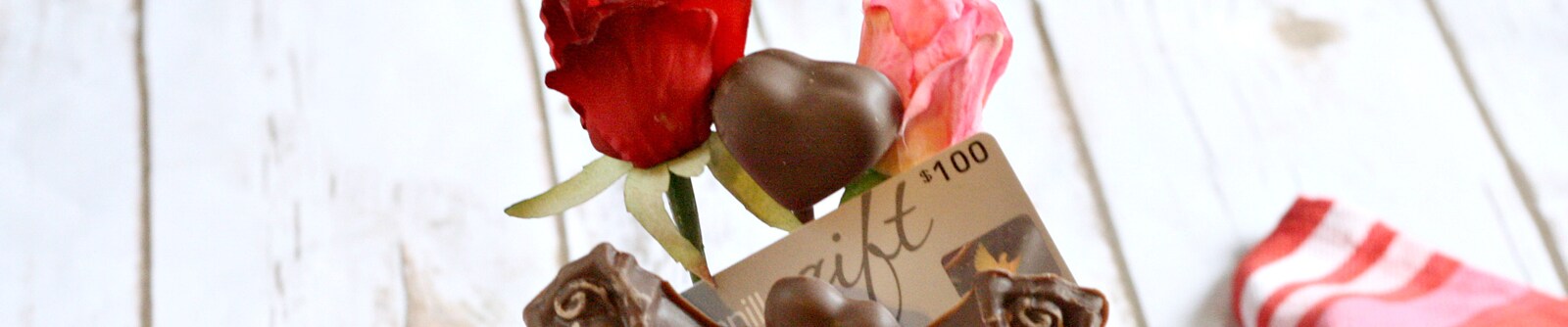Close up of roses, chocolates and a $100 gift card