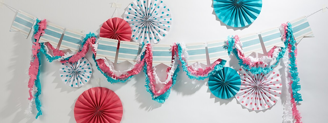 Colorful hanging garlands, streamers and folded paper origami