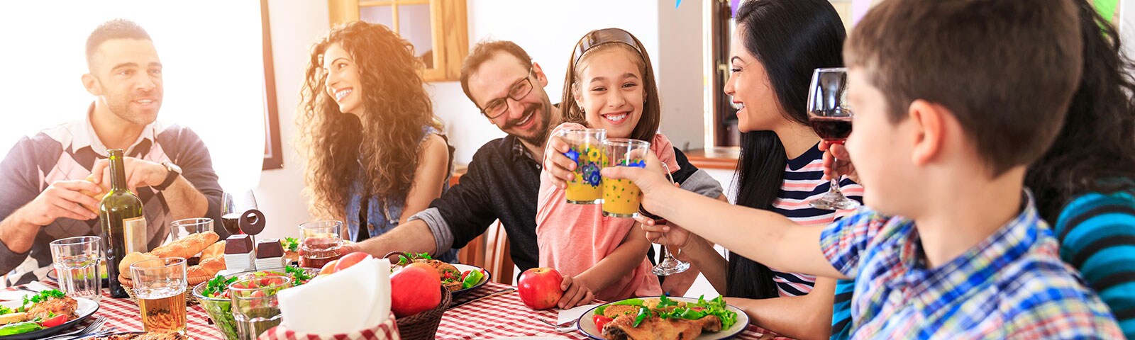 Family and friends gathering around table with drinks